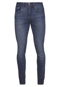 Tajta jeans i mörkblå denim med en slät yta, med fem fickor, en framskjutande knapp och dragkedja.