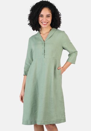 Grünes Leinenkleid mit Kragen, Dreiviertelärmeln und seitlichen Taschen, das einen lässigen Schnitt und Knopfdetails auf der Vorderseite aufweist.