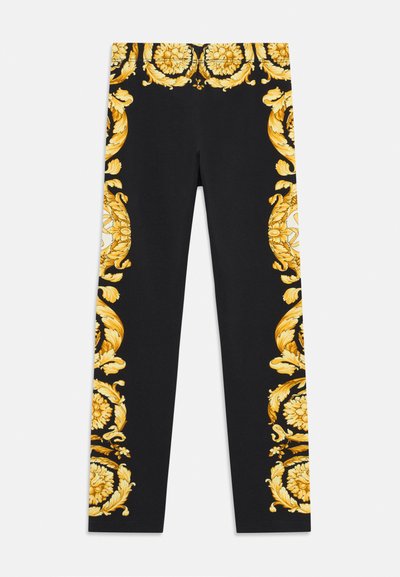 Fekete leggings, bonyolult arany virágmintákkal az oldalán, rugalmas anyagból készült a kényelem és a megfelelő illeszkedés érdekében.
