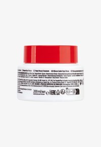 Contenitore circolare bianco con coperchio rosso, con etichette testurizzate in più lingue che indicano dettagli del prodotto e volume (200 ml).