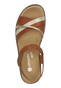 Braune Leder-Sandale mit kreuzweise angeordneten Riemen in metallischem Creme und Beige. Weiche Innensohle mit Branding. Abgerundete Zehenpartie und genähte Kanten.