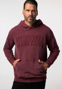 Felpa borgogna con tasca frontale, caratterizzata dal logo "HAWK" in rilievo. Tessuto morbido e testurizzato con cappuccio regolabile.