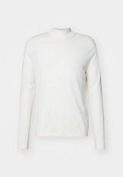 Maglione a collo alto bianco a maniche lunghe realizzato in un tessuto morbido. Presenta un design aderente e dettagli minimi, con un orlo dritto semplice.