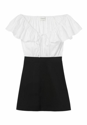 Haut décolleté avec un corsage en coton blanc orné de volants et de motifs à œillets ; jupe noire ajustée.