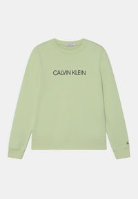 Světlě zelený svetr s dlouhými rukávy, kulatým výstřihem a nápisem "CALVIN KLEIN" vytištěným černě na hrudi. Hladké manžety a lem.