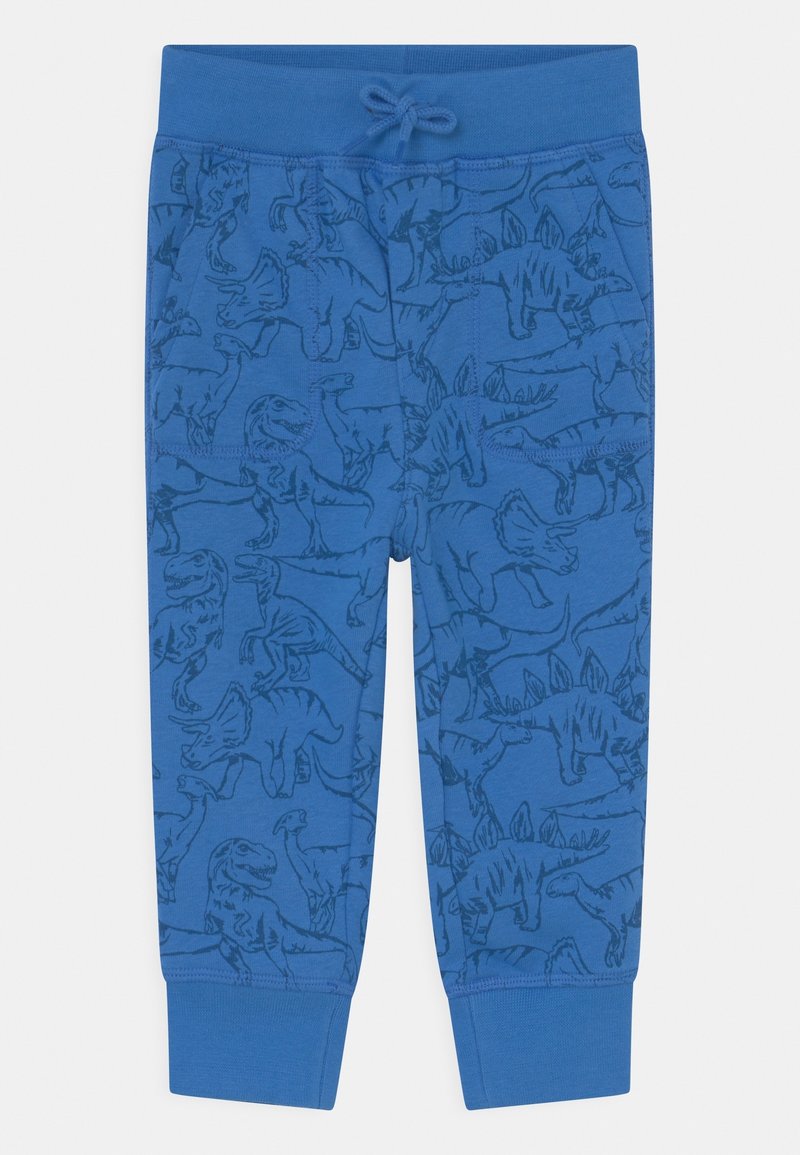 Pantalon en coton bleu avec un imprimé dinosaure en bleu plus foncé. Il présente une ceinture élastiquée avec un cordon de serrage et des poignets côtelés.