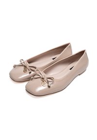 Beige patent leather ballet flats with a square toe, bow detail, and gold accent. Smooth texture with elastic trim for a snug fit.