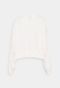 Vit kortärmad sweatshirt med en texturerad design och subtila logomönster, långa ärmar och rund halsringning. Slät tyg.