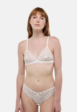 Ensemble soutien-gorge en dentelle et culotte assortie en crème clair. Comprend un motif complexe de feuilles, des bretelles réglables et un tissu doux et texturé.