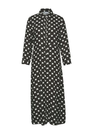 Długa, czarno-biała sukienka zapinana na guziki z kołnierzykiem i dużym, okrągłym wzorem w kropki na całej powierzchni.
