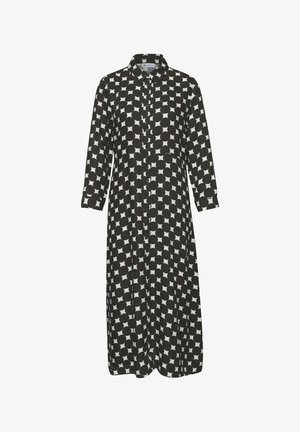 Długa, czarno-biała sukienka zapinana na guziki z kołnierzykiem i dużym, okrągłym wzorem w kropki na całej powierzchni.