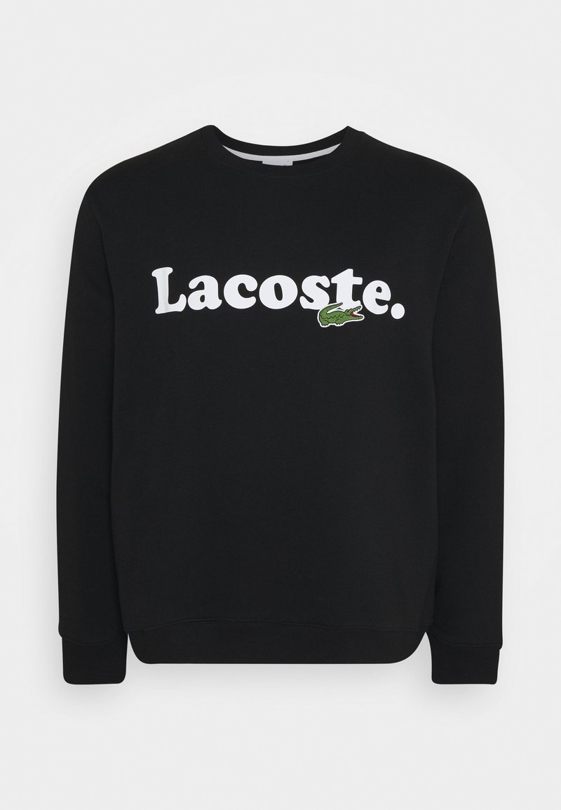 Sweat-shirt noir à manches longues avec le texte blanc "Lacoste." et un petit logo de crocodile vert sur la poitrine.