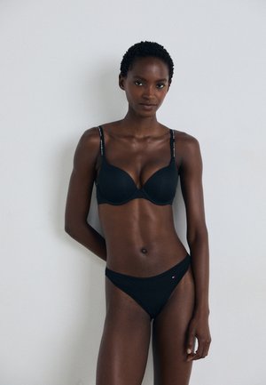 Black plunge bra with adjustable straps and a smooth finish, paired with matching black bikini briefs featuring a small logo detail.