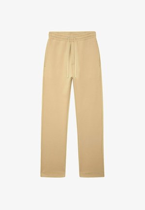 Pantalons de survêtement beige à cordon de serrage avec taille élastique et poches latérales, design à jambes droites, posés à plat sur un fond blanc.