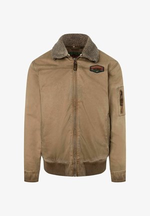 Braune Bomberjacke mit flauschigem Kragen, Reißverschluss und Patches auf der Brust. Mit gerippten Bündchen und Taillenbund.