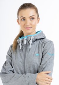 Grå zip-up hoodie med en turkos inre foder, featuring en dragsko i huvan, broderad paraplylogga och texturerad tyg.