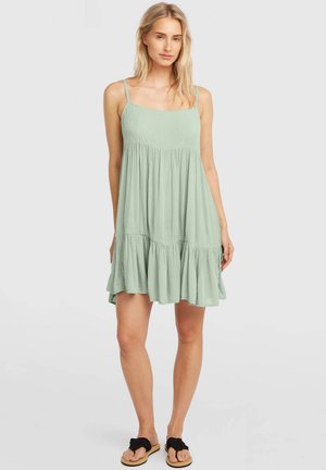 Šviesiai žalia rankovių suknelė su prigludusia liemene ir išplatėjusiu sluoksniuotu sijonu. Pagaminta iš tekstūruotos medžiagos, turi plonas petnešėles ir laisvą siluetą.