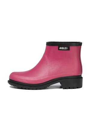 Ankle-high pink rubber rain boot with black sole, heel, and trim, featuring a small rectangular black label with white "AIGLE 1853" text.
