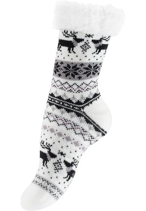 Chaussette en tricot blanche avec un revers blanc duveteux, ornée de rennes noirs, de flocons de neige et de motifs géométriques en gris et violet.