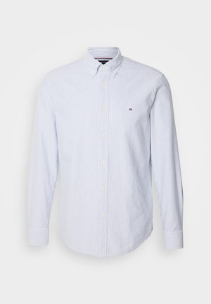 Világoskék és fehér csíkos gombos ing, pamut anyagból, hosszú ujjú, gallérral és egy kis logóval a mellrészen.