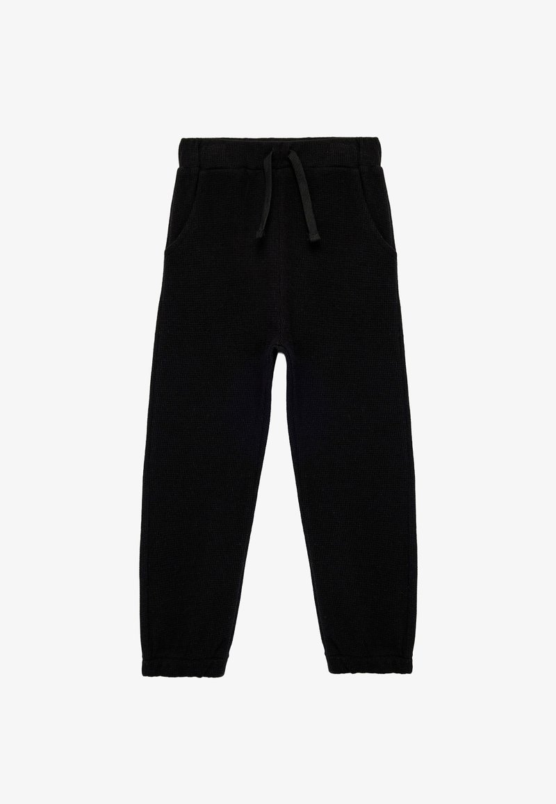 Sorte sweatpants med waffle-tekstur, elastisk talje og snøre. Har to sidelommer og smalle benåbninger.