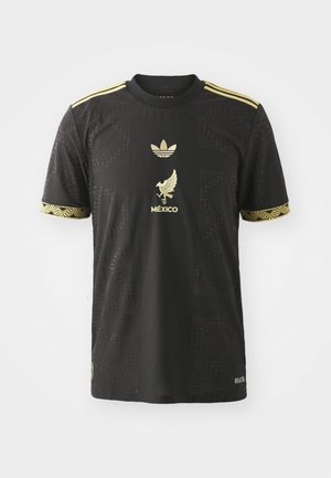 Black athletic shirt with gold accents, featuring a textured pattern, embroidered eagle logo, and classic three-stripe design on sleeves.
