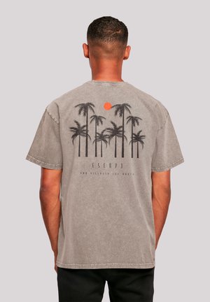 Gray cotton T-shirt featuring a graphic of palm trees and a sun, with the text "ESCAPE AND DISCOVER THE WORLD" in black underneath.