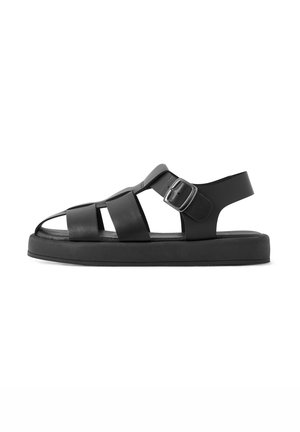 Black leather sandals with wide straps, open toe design, adjustable buckle closure, and a thick black sole for comfort.