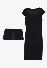 Robe noire avec des manches courtes, décolleté carré, fermeture éclair dans le dos. Accompagnée d'une ceinture noire assortie avec une boucle rectangulaire et un détail plissé.