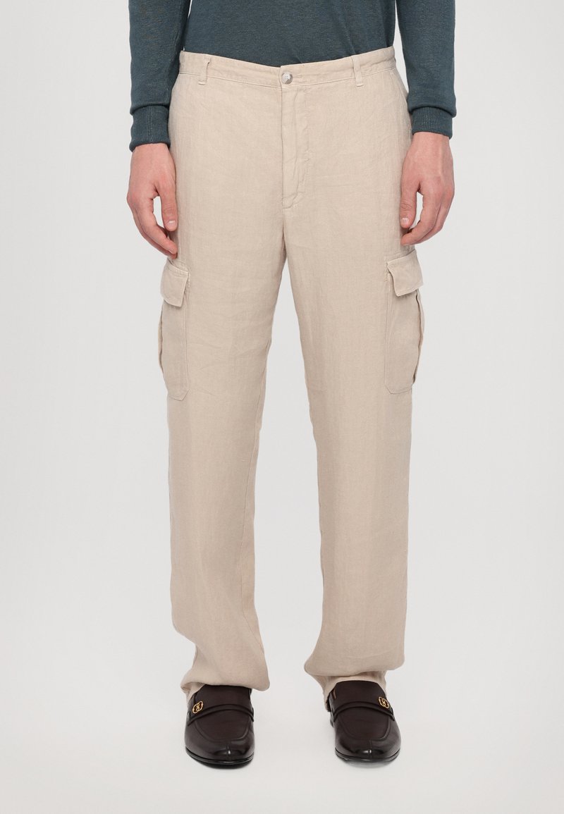 Beige linnen cargo shorts met zijzakken, voorzien van een knoopsluiting en een rechte pasvorm. Zachte textuur en lichtgewicht materiaal.