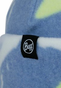 Blue fleece hat with white and yellow abstract patterns, featuring a small black label with "Buff" logo. Soft texture and rounded shape.