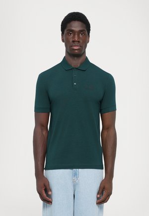 Dark green polo shirt with short sleeves, button placket, and textured fabric; features a subtle logo on the chest.