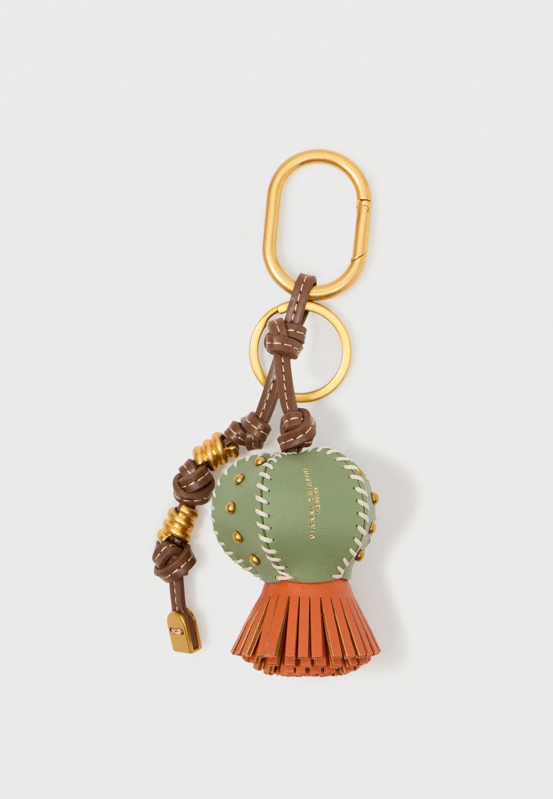 Klahvaketita accessor, millel on roheline nahkpall valge õmblusega, oranž pits alaosas, kuldne riistvara ja pruun punutud aas.