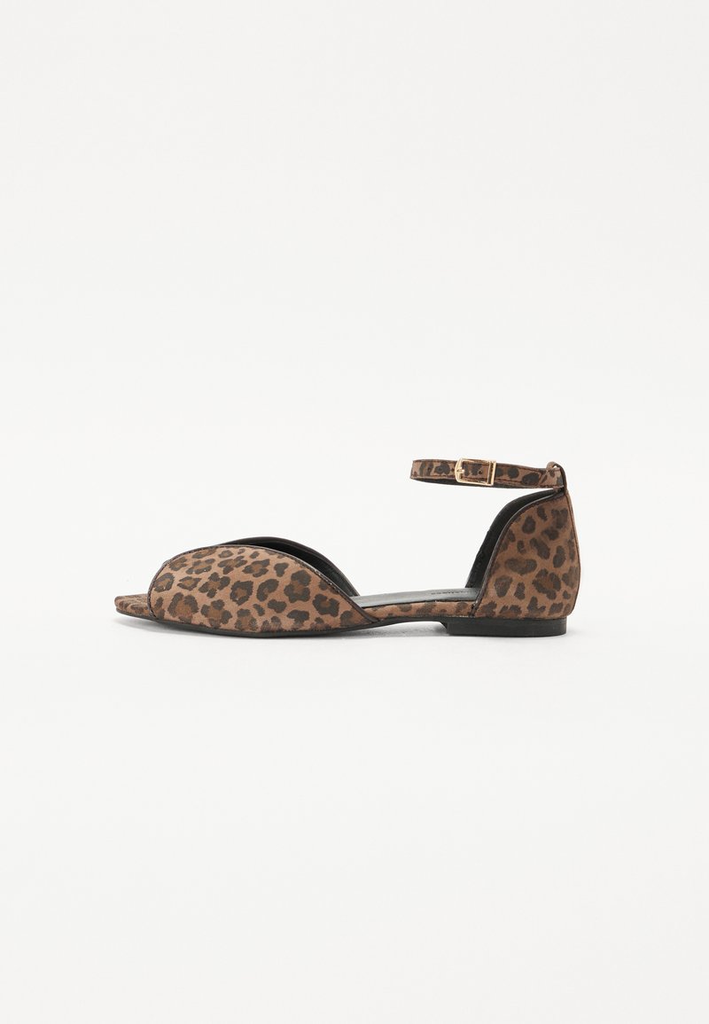 Leopard print flat sandal with open toe design, ankle strap, brown suede material, and a low black sole. Detailed stitching on edges.