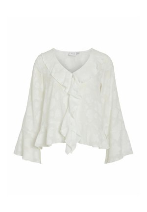 Hvit bluse med volangkant ved halsen og knytebånd foran. Har klokkeformede ermer og et subtilt blomsterprint i et lett stoff.