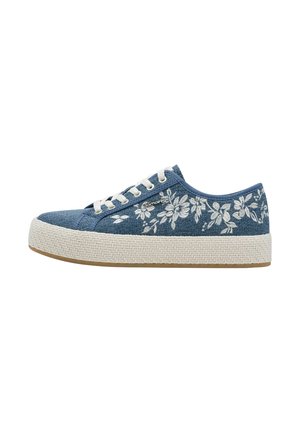 Blue denim sneakers with white floral embroidery, textured rope midsole, and white laces. Flat rubber outsole. Low-top design.
