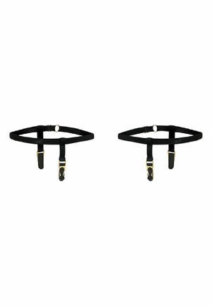 Sangles de harnais ajustables noires avec quincaillerie dorée, comportant des clips et des boucles pour la fixation. Texture lisse et design minimal.