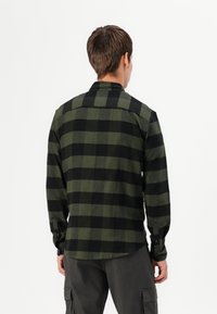 Groen-zwart geruit flanellen overhemd, lange mouwen, knoopmanchetten, zachte textuur, rechte snit met rugpand en afgeronde zoom.