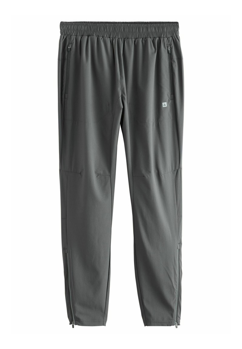 Pantalones deportivos grises con cintura elástica, bolsillos laterales y cremalleras en los tobillos. Fabricados con una tela ligera y suave.