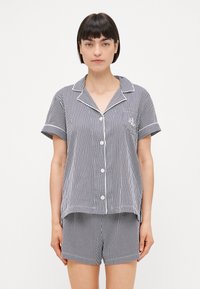 Randig pyjamaset i marinblått och vitt, med kortärmad topp med krage, knappstängning och matchande shorts med elastisk midja.