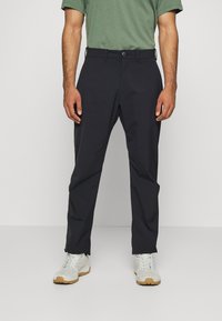 Dark navy trousers with a straight leg fit, made from lightweight fabric, featuring a button closure and belt loops, paired with white sneakers.