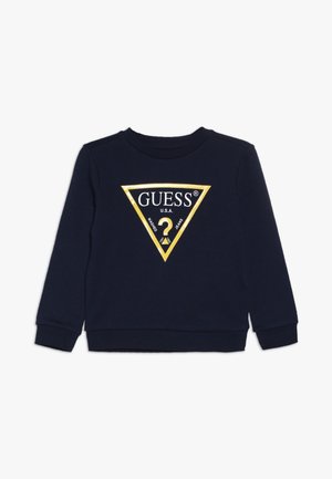 Marineblauwe trui met lange mouwen, ronde hals en een drihoekig goudkleurig logo met de teksten "GUESS" en "U.S.A." op de voorkant.