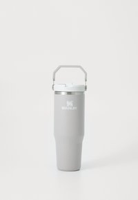 Gray stainless steel travel mug with a tapered design, white plastic lid, and a metal handle for easy carrying. Features a logo on the front.