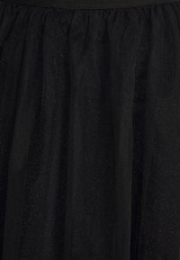 Black tulle skirt featuring a textured, layered design with a soft, sheer finish and subtle sparkles throughout.