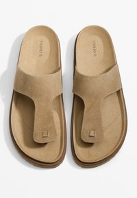 Bruna mockaklädda sandaler med design för tåpost. Platt sula med en sömlös vadderad fotbädd. Storlek 37 markerad på innersulan.
