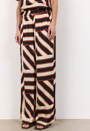 Wide-leg trousers made of lightweight fabric, featuring a bold geometric pattern of cream, black, and rust stripes, with an elastic waistband.