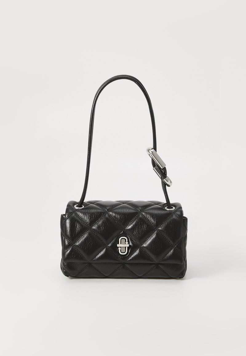 Bolsa de mão em pele preta acolchoada com fecho prateado, de forma cilíndrica e alça de ombro ajustável, em fundo branco.