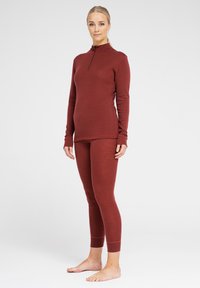 Maroon thermal set featuring a long-sleeve top with a half-zip and fitted leggings, made from a textured, stretchy material.