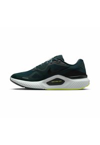 Zapatilla de correr de Nike con una parte superior de malla verde oscuro, acentos negros y una mediasuela texturizada blanca que presenta un detalle del sistema de soporte amarillo.