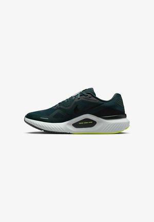 Chaussure de course Nike avec un dessus en maille vert foncé, des accents noirs et une semelle intermédiaire texturée blanche avec un détail de système de soutien jaune.